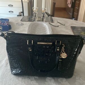 A leather shoulder handbag made by Brahmin.